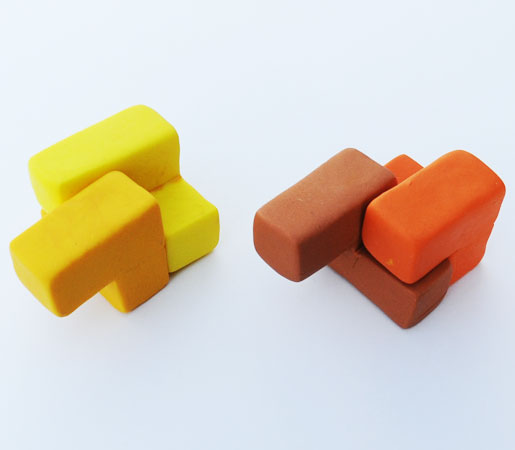 The two yellow Squiggles are incapable of mating into a cube, and the Orange and Brown Squiggles can't do it either